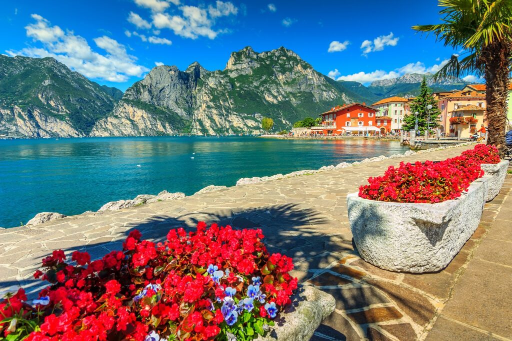 Mountains and walkway at Lake Garda in Italy's Northern lake region.