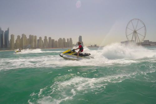 Dubai jet ski with ferris wheel and city in background