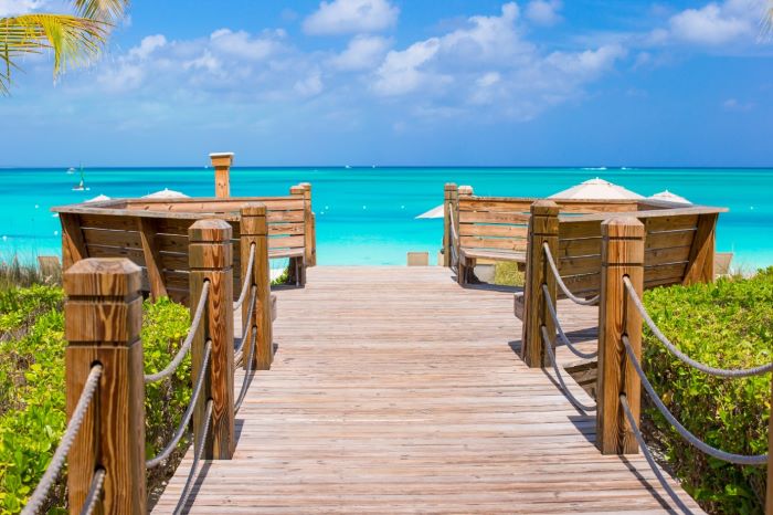 Boardwalk to clear blue sea and sky Providenciales Turks and Caicos