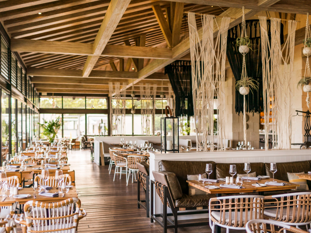 Bohemian 2087 restaurant at UNICO with floor to ceiling windows and macrame decor