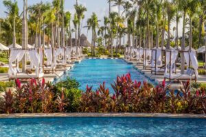 Secrets royal beach quiet pool with vegetation and pool seating on all sides