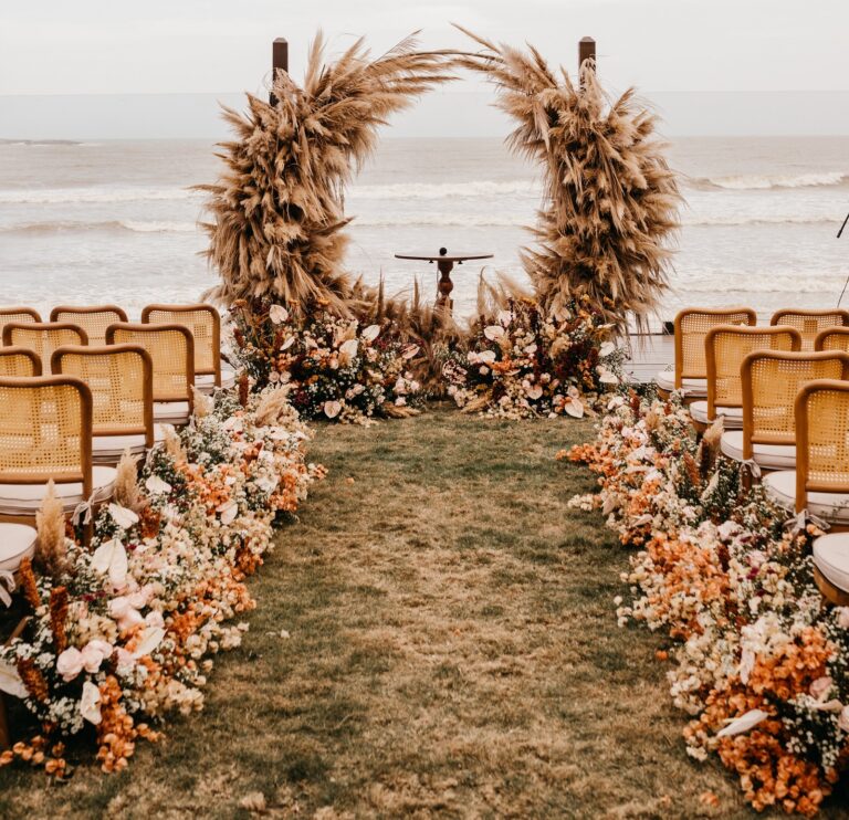 Beach destination wedding set up using local flowers. This represents supporting the local economy which is one of the 8 Destination Wedding Positive Impacts